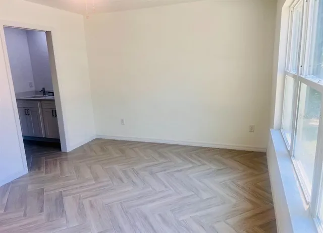 a view of an empty room and wooden floor