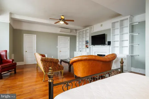 a bedroom with furniture and a flat screen tv