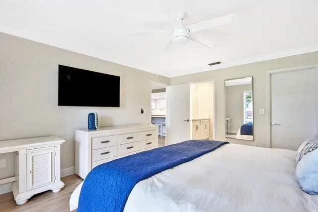 a bedroom with a bed and a flat screen tv