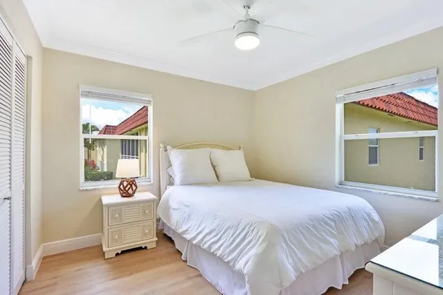 a bedroom with a bed and large window