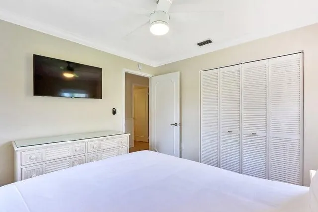 a bedroom with a bed and a flat screen tv