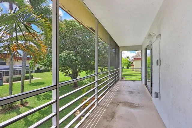 a view of a room with wooden floor and windows