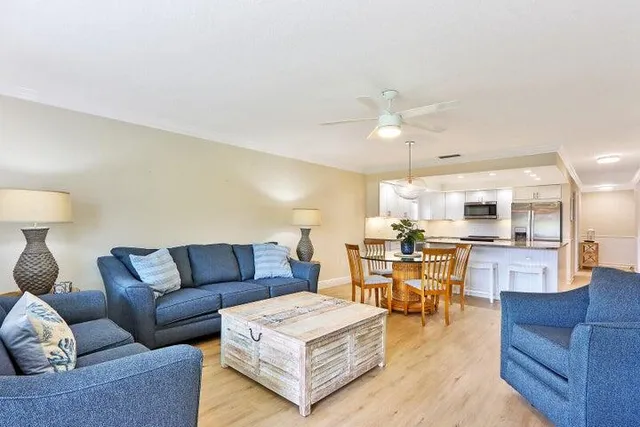 a living room with furniture and kitchen view