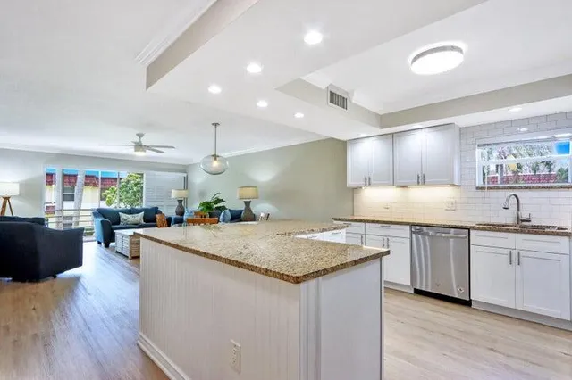 a kitchen with sink and cabinets