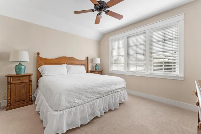 a bedroom with a bed and a mirror on a dresser