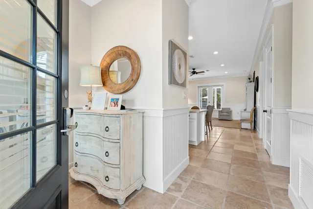 a view of a bathroom with a sink mirror and window