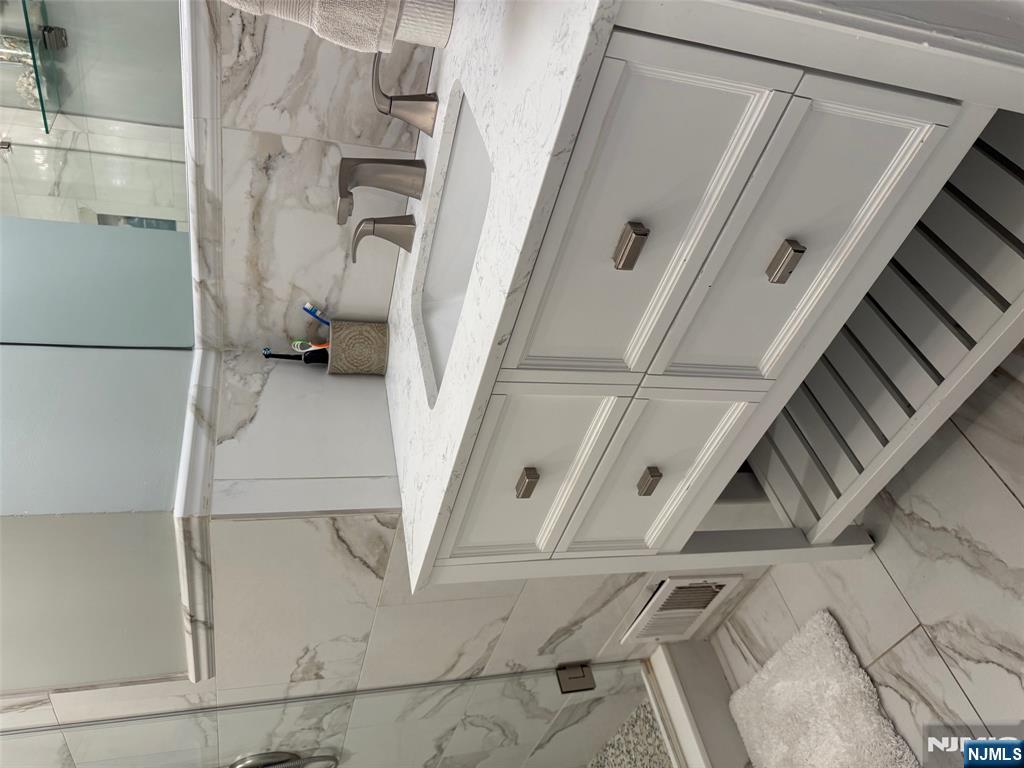 16 Lawrence Road Wayne, NJ 07470 - Photo 14 of 28 a bathroom with a sink and a mirror