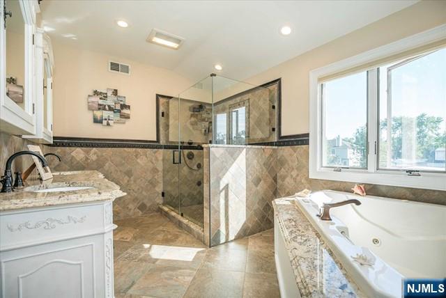 16 Lawrence Road Wayne, NJ 07470 - Photo 17 of 28 a bathroom with a tub sink and mirror