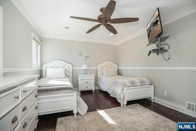 16 Lawrence Road Wayne, NJ 07470 - Photo 22 of 28 a spacious bedroom with a bed and a chandelier