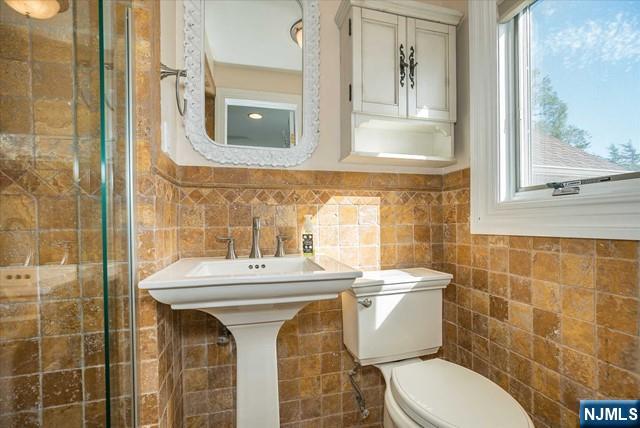 16 Lawrence Road Wayne, NJ 07470 - Photo 23 of 28 a bathroom with a sink mirror toilet and shower
