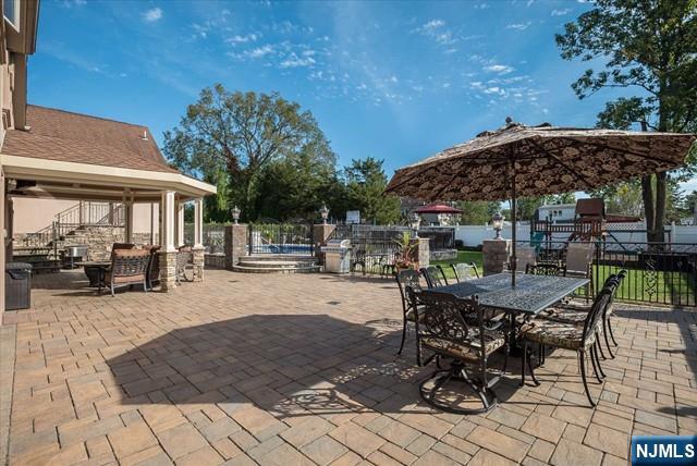 16 Lawrence Road Wayne, NJ 07470 - Photo 25 of 28 a patio with a table and chairs and potted plants
