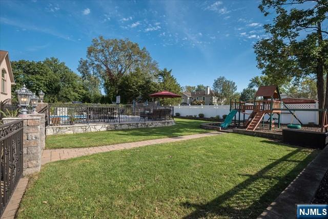 16 Lawrence Road Wayne, NJ 07470 - Photo 26 of 28 a view of a swimming pool with a garden and trees