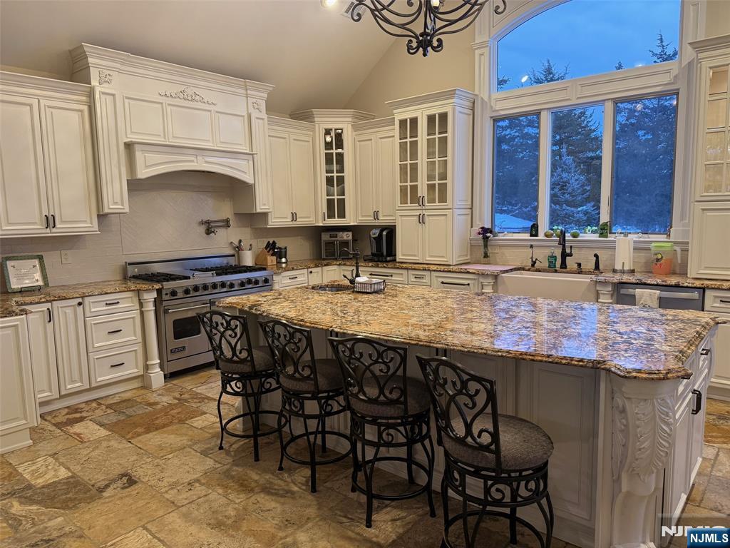 16 Lawrence Road Wayne, NJ 07470 - Photo 4 of 28 a kitchen with a stove a sink and white cabinets