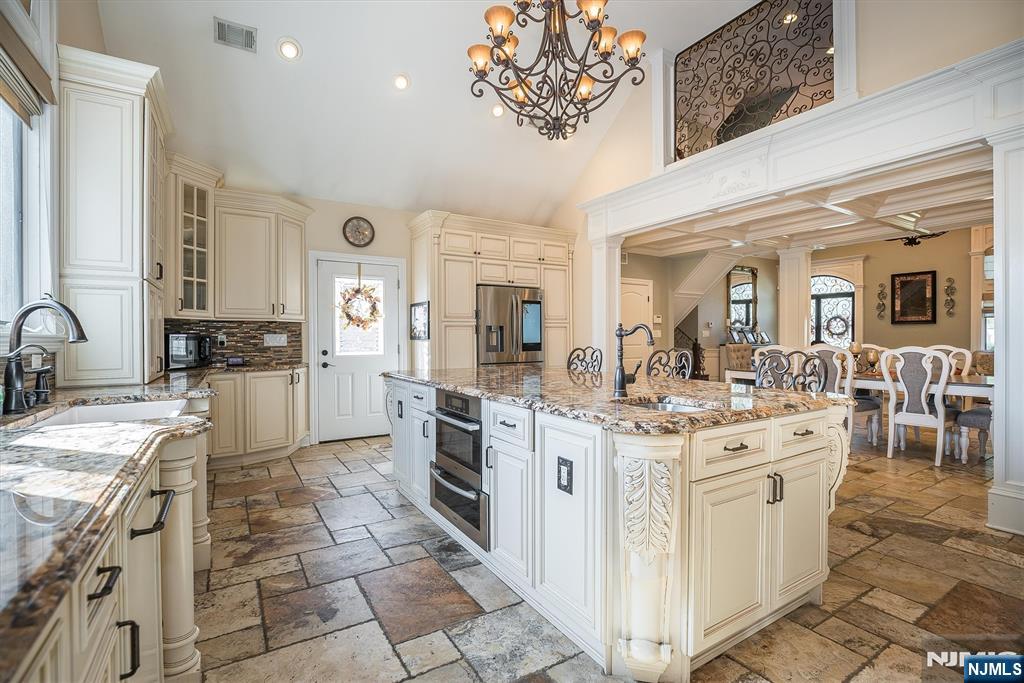 16 Lawrence Road Wayne, NJ 07470 - Photo 5 of 28 a kitchen with a stove a sink and a refrigerator