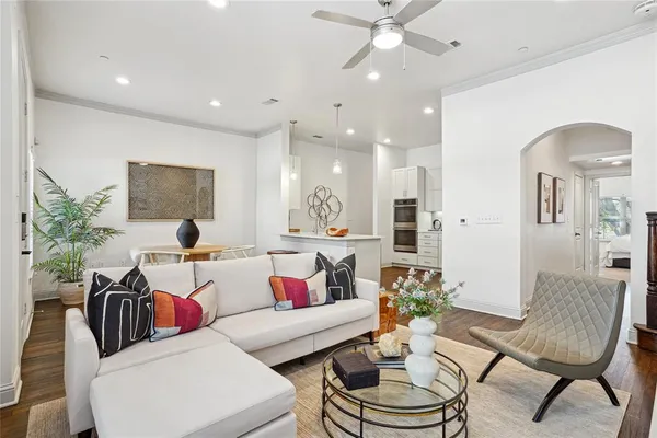 a living room with furniture and a chandelier