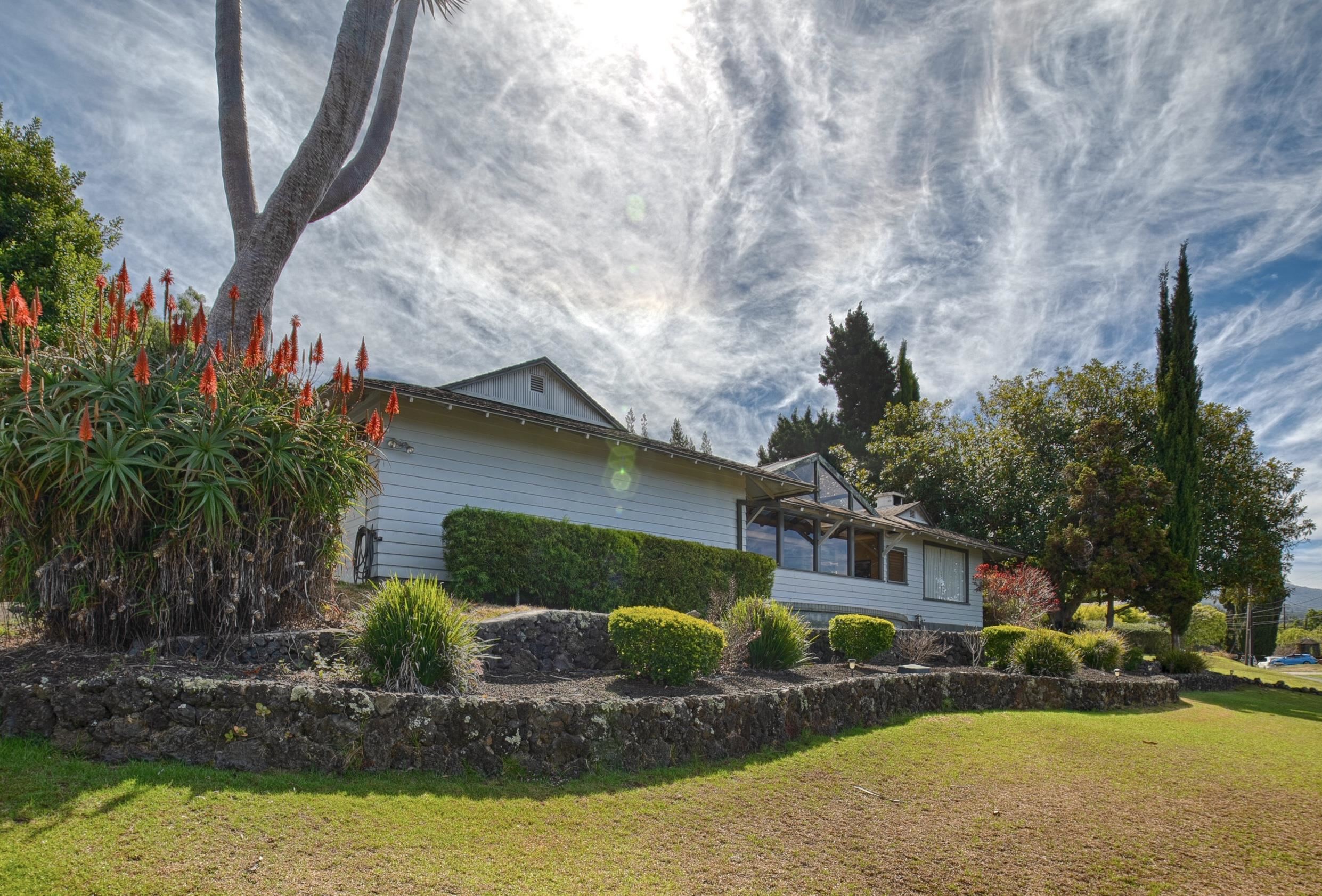 100 A Ihe Place Kula, HI 96790 - Photo 2 of 21 a front view of a house with garden