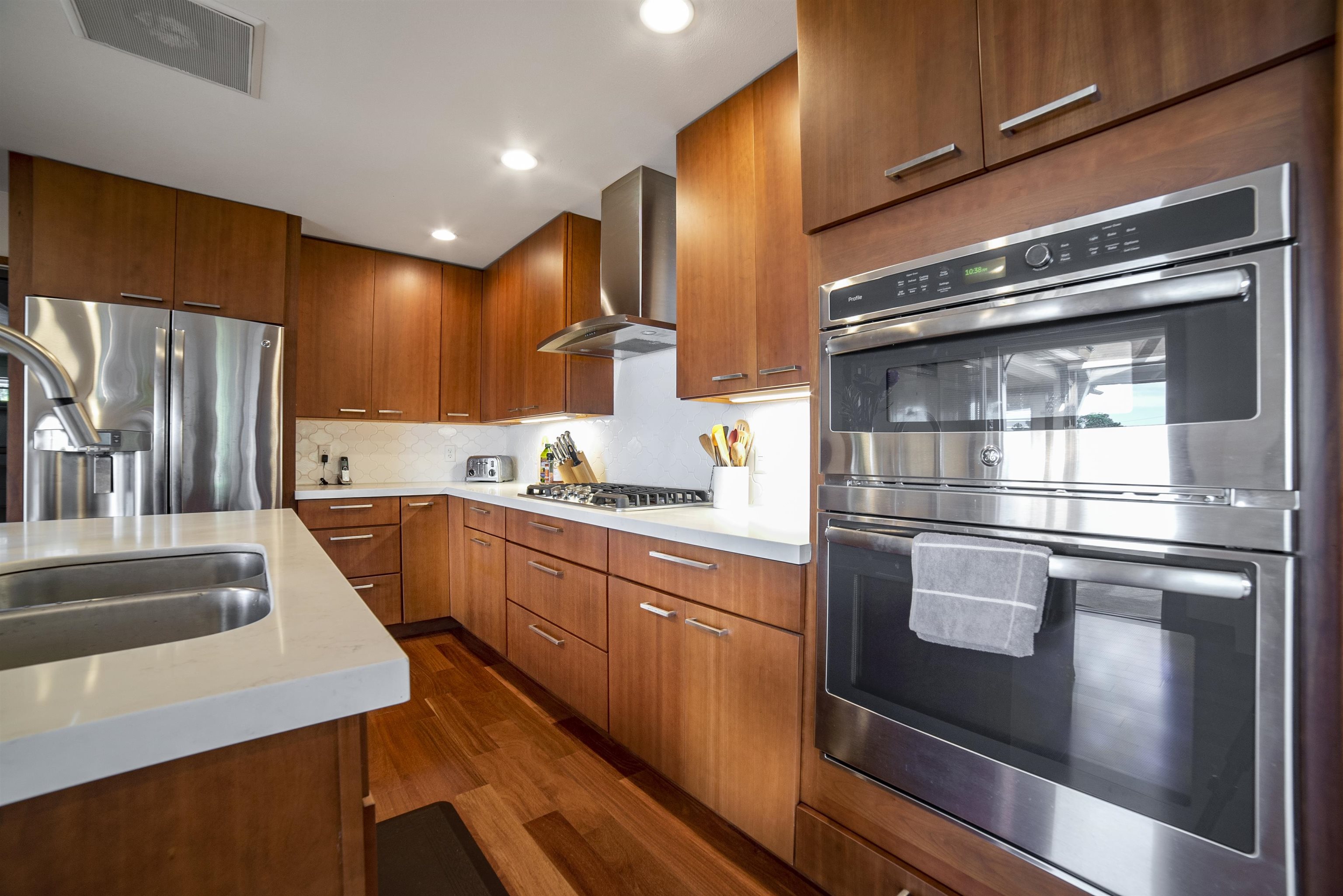100 A Ihe Place Kula, HI 96790 - Photo 7 of 21 a kitchen with stainless steel appliances kitchen island granite countertop a refrigerator stove and sink