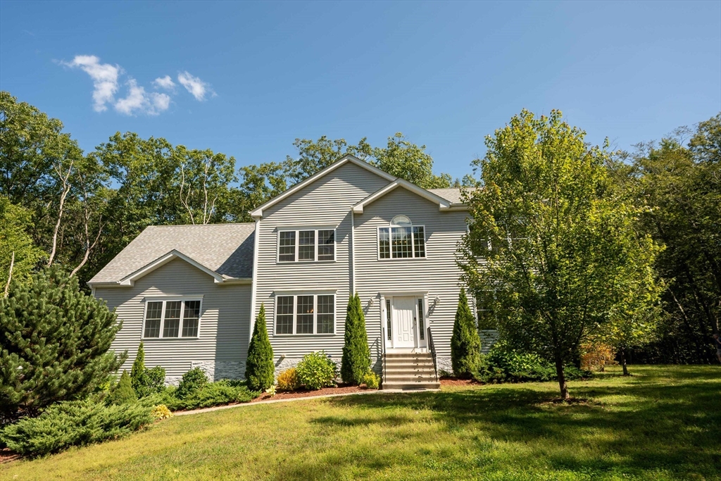 a front view of a house with a yard