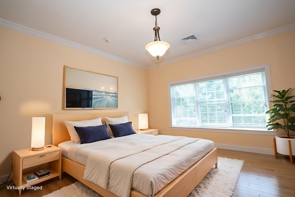 4 Farrar Road Upton, MA 01568 - Photo 18 of 37 a bedroom with a large bed and a chandelier