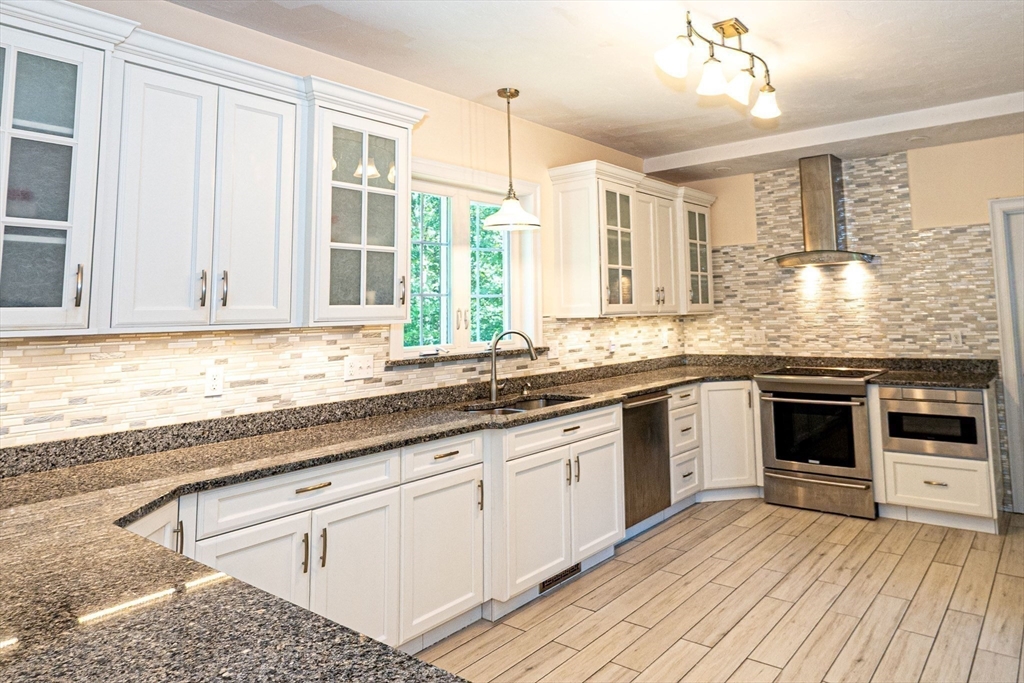 4 Farrar Road Upton, MA 01568 - Photo 4 of 37 a kitchen with granite countertop white cabinets and white appliances