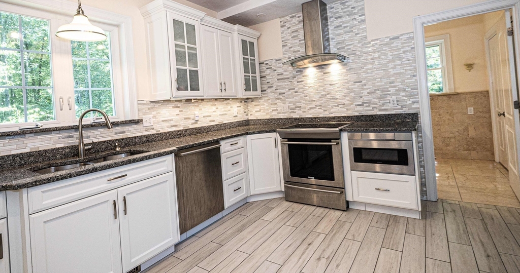 4 Farrar Road Upton, MA 01568 - Photo 6 of 37 a kitchen with stainless steel appliances a stove sink and cabinets