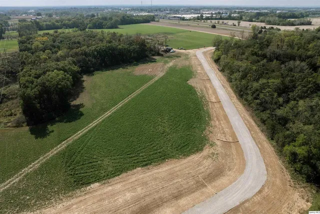 an aerial view of a house with a yard and lake view