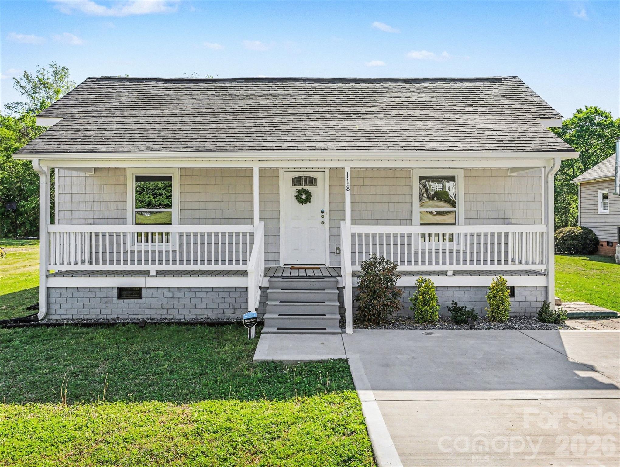 118 Glen Rae Street Southwest Concord, NC 28025 - Photo 2 of 19 a front view of a house with a yard and potted plants