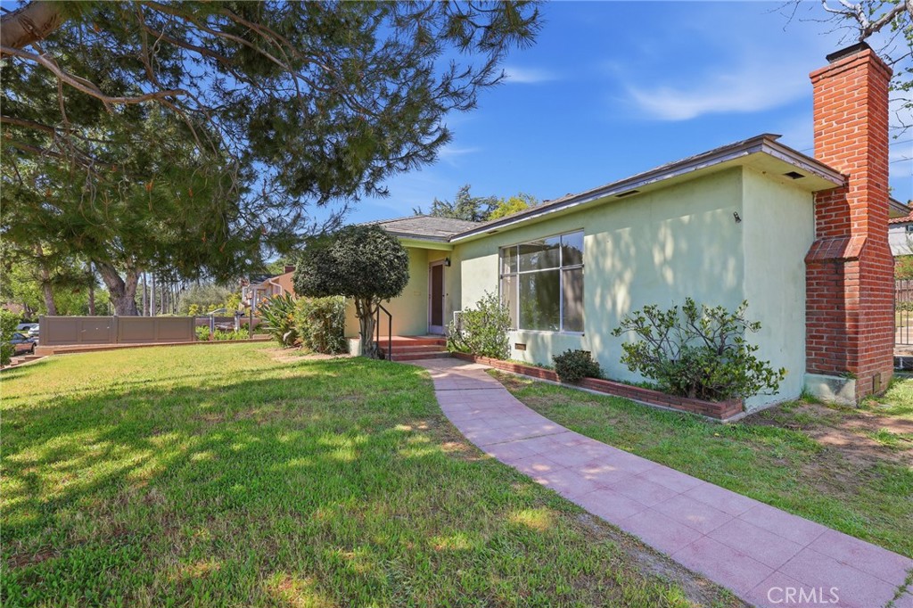 1295 East Woodbury Road Pasadena, CA 91104 - Photo 1 of 1 a view of a house with backyard and a tree