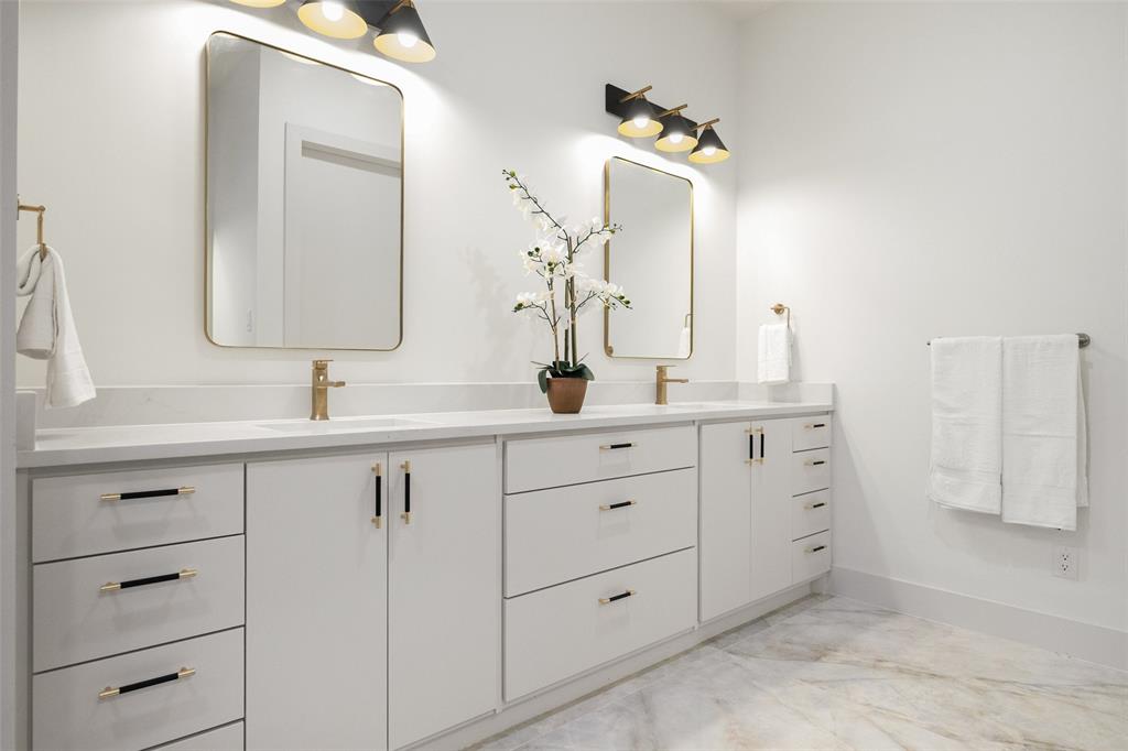 3940 North Cresthaven Road Dallas, TX 75209 - Photo 17 of 24 a bathroom with a double vanity sink and a mirror