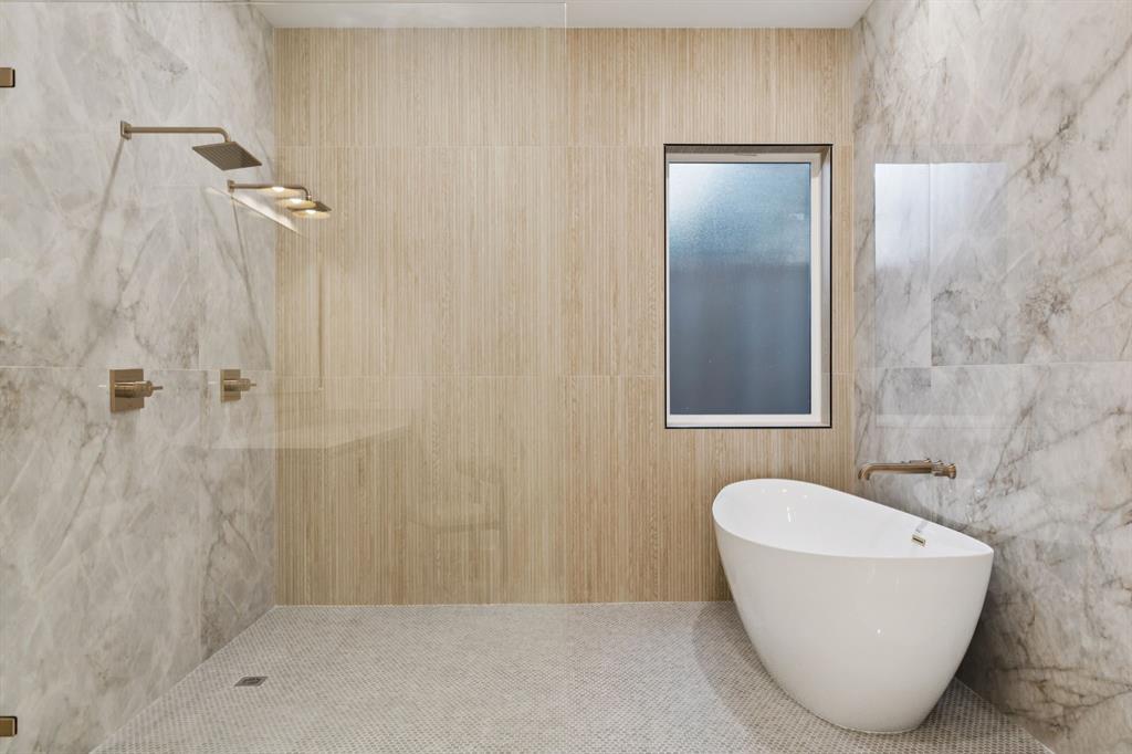 3940 North Cresthaven Road Dallas, TX 75209 - Photo 8 of 24 a bathroom with a tub and shower