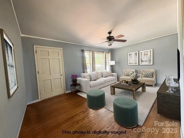 a living room with furniture a bed and a chandelier