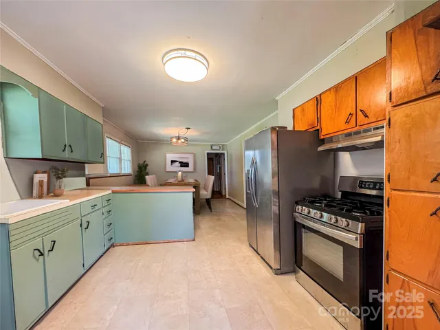 a kitchen with cabinets and steel stainless steel appliances