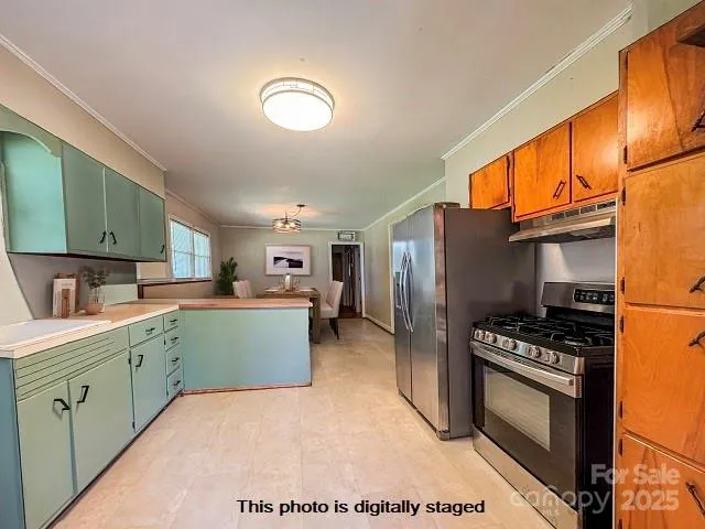 a kitchen with cabinets and steel appliances
