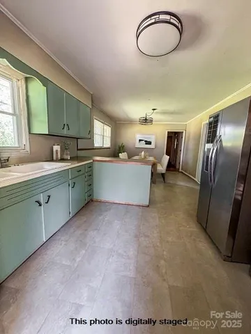 a kitchen with stainless steel appliances granite countertop a sink window and cabinets