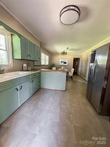 a kitchen with stainless steel appliances granite countertop a sink refrigerator stove and microwave