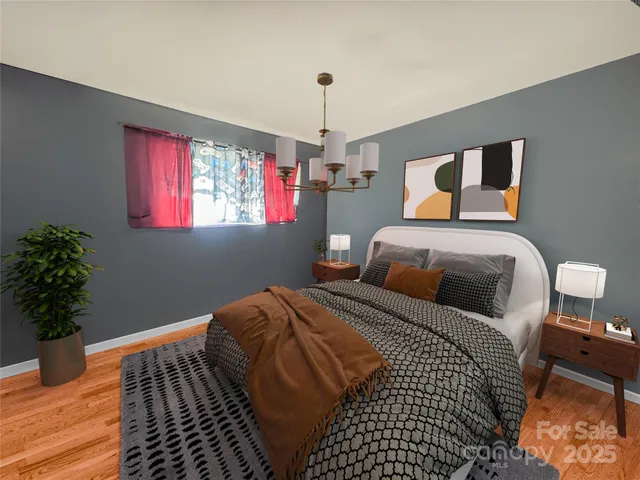 a bedroom with bed and a potted plant