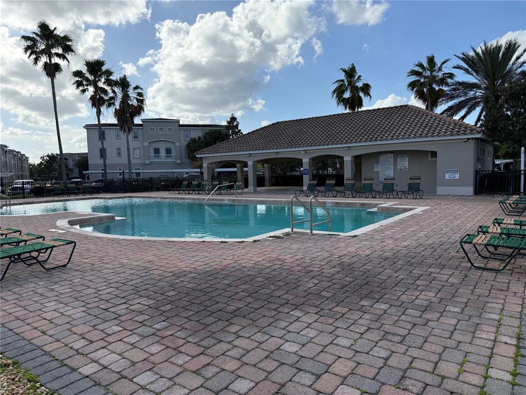a view of a house with backyard and sitting area