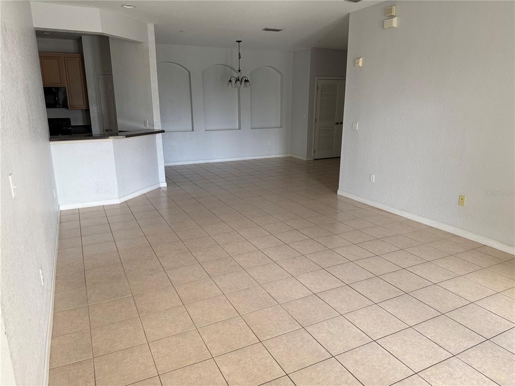3311 Whitestone Circle, Unit 201 Kissimmee, FL 34741 - Photo 12 of 25 an empty room with a fireplace and cabinet