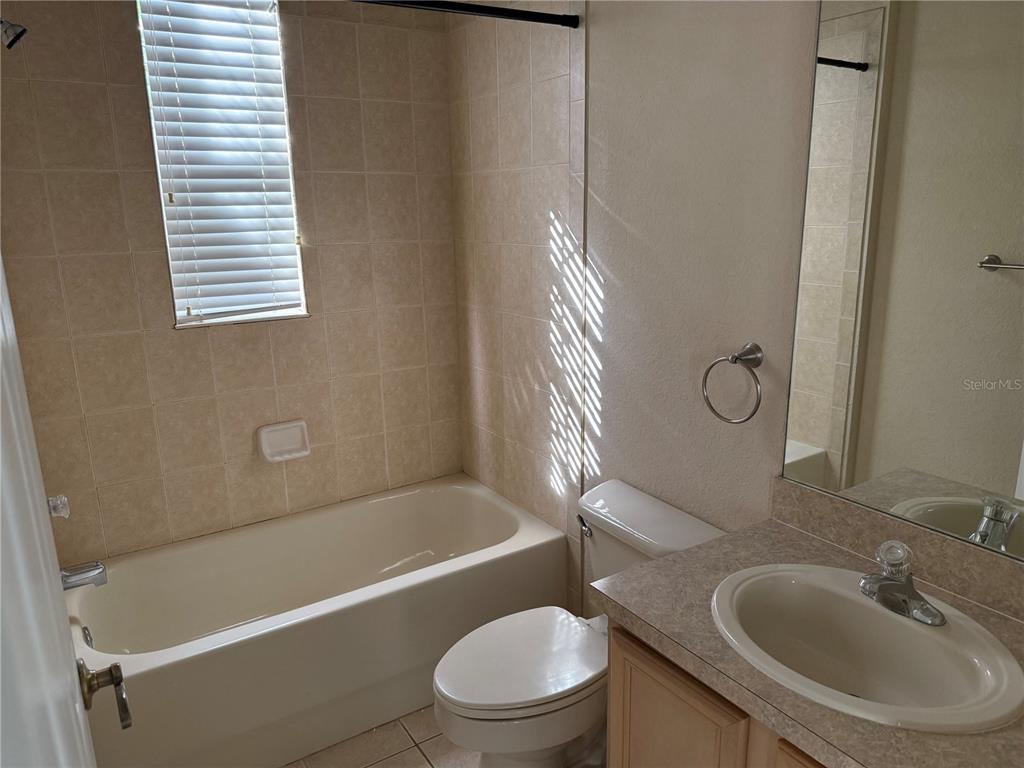 3311 Whitestone Circle, Unit 201 Kissimmee, FL 34741 - Photo 15 of 25 a bathroom with a sink a toilet and shower
