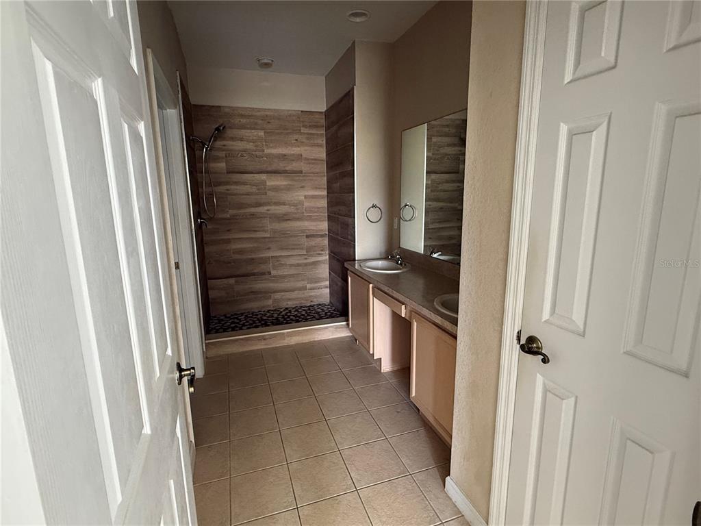 3311 Whitestone Circle, Unit 201 Kissimmee, FL 34741 - Photo 19 of 25 a view of a hallway with wooden shelves