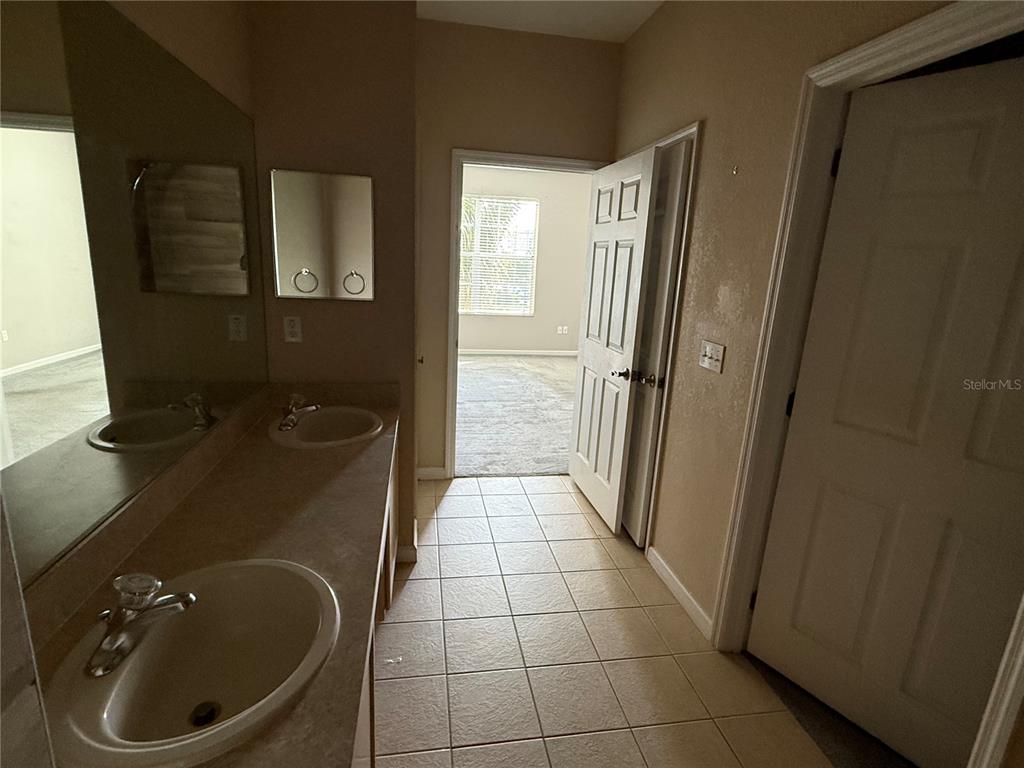 3311 Whitestone Circle, Unit 201 Kissimmee, FL 34741 - Photo 21 of 25 a bathroom with a sink and a mirror