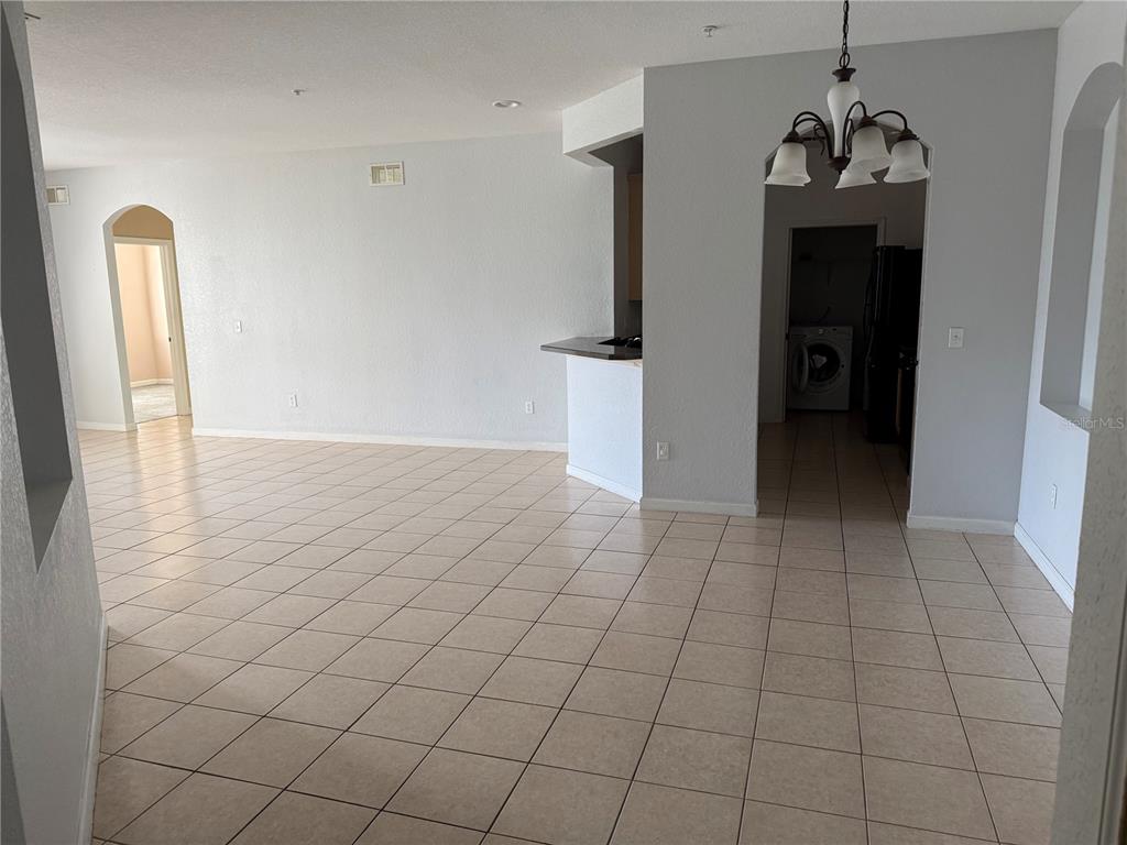 3311 Whitestone Circle, Unit 201 Kissimmee, FL 34741 - Photo 5 of 25 a view of a hallway with wooden floor and a chandelier