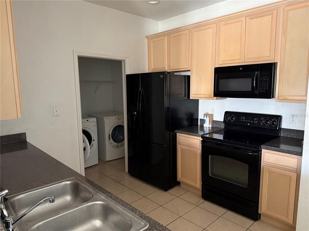 3311 Whitestone Circle, Unit 201 Kissimmee, FL 34741 - Photo 7 of 25 a kitchen with a refrigerator stove and microwave