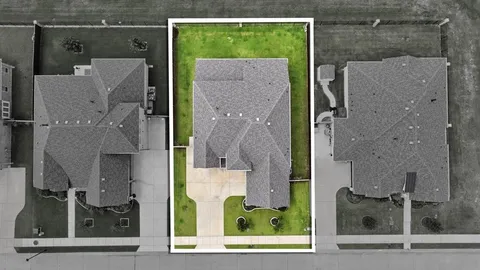 an aerial view of a residential apartment building with a yard