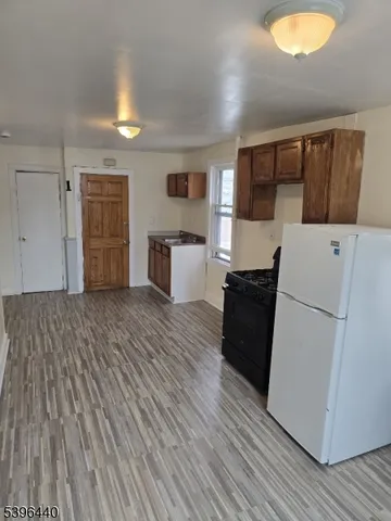 a view of kitchen and wooden floor