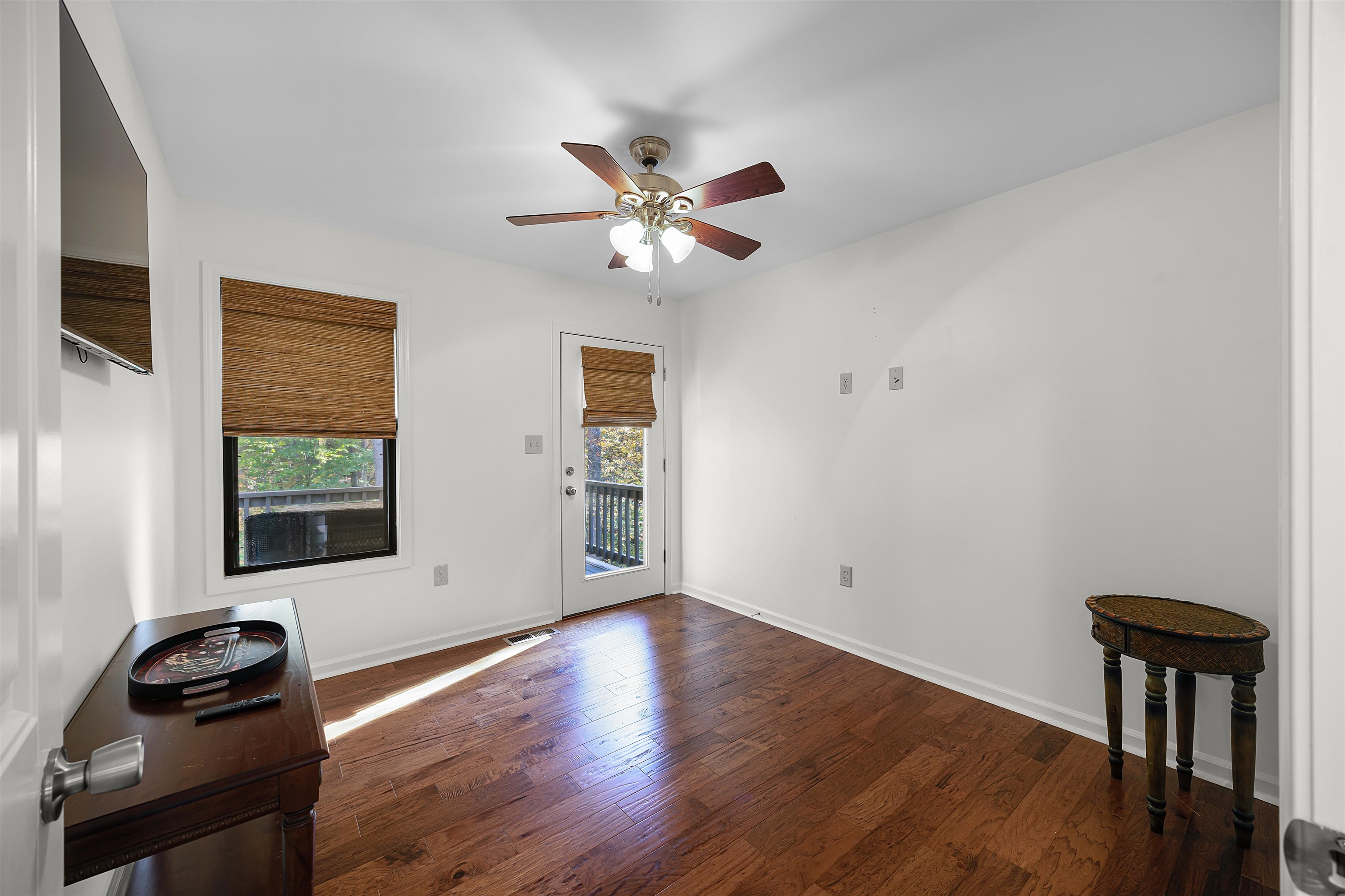 145 Chval Drive Counce, TN 38326 - Photo 20 of 28 a view of a livingroom with wooden floor and a ceiling fan