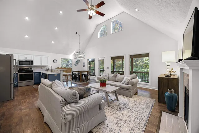 a living room with furniture fireplace and a window