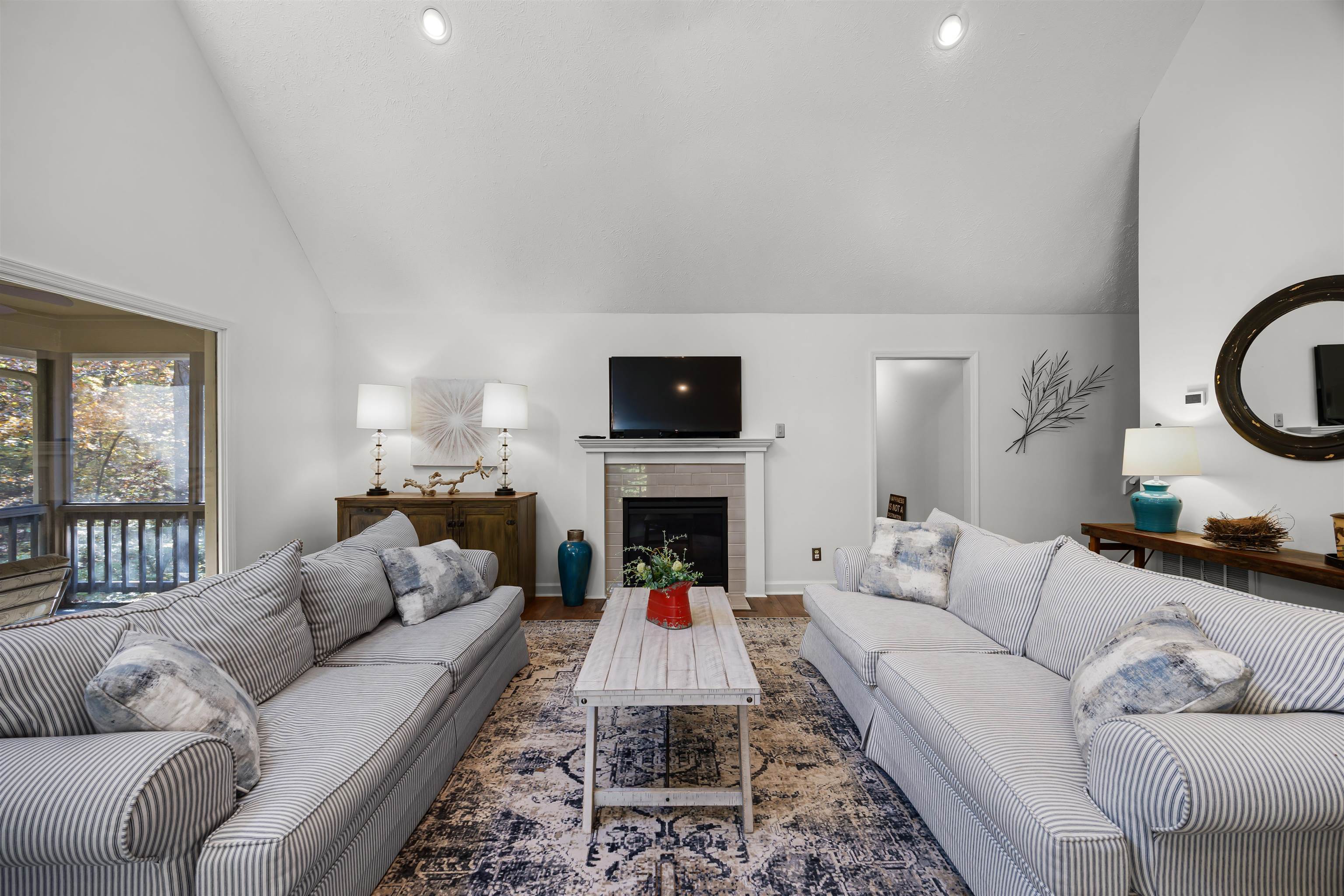 145 Chval Drive Counce, TN 38326 - Photo 6 of 28 a living room with furniture a fireplace and a flat screen tv