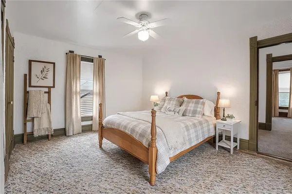 a bedroom with a bed and a chandelier