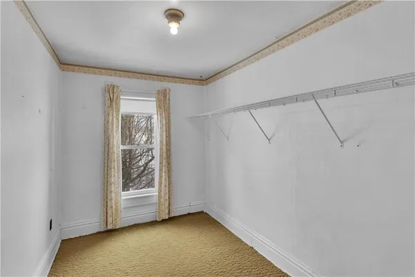 a view of an empty room with brick walls